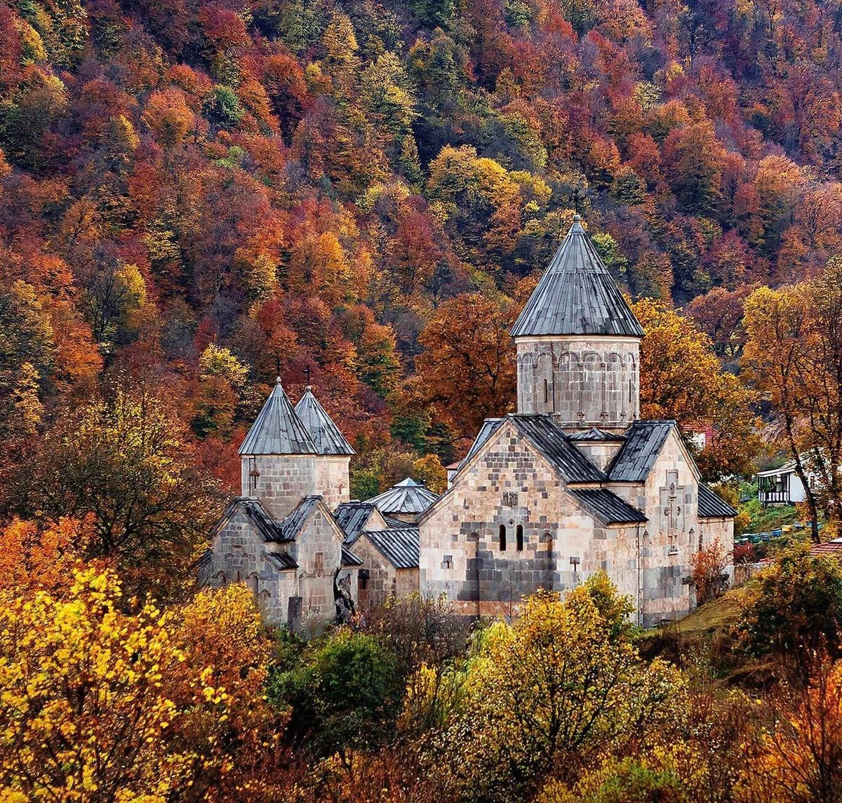 Haghartsin Monastery surrounded by autumn forest near Dilijan